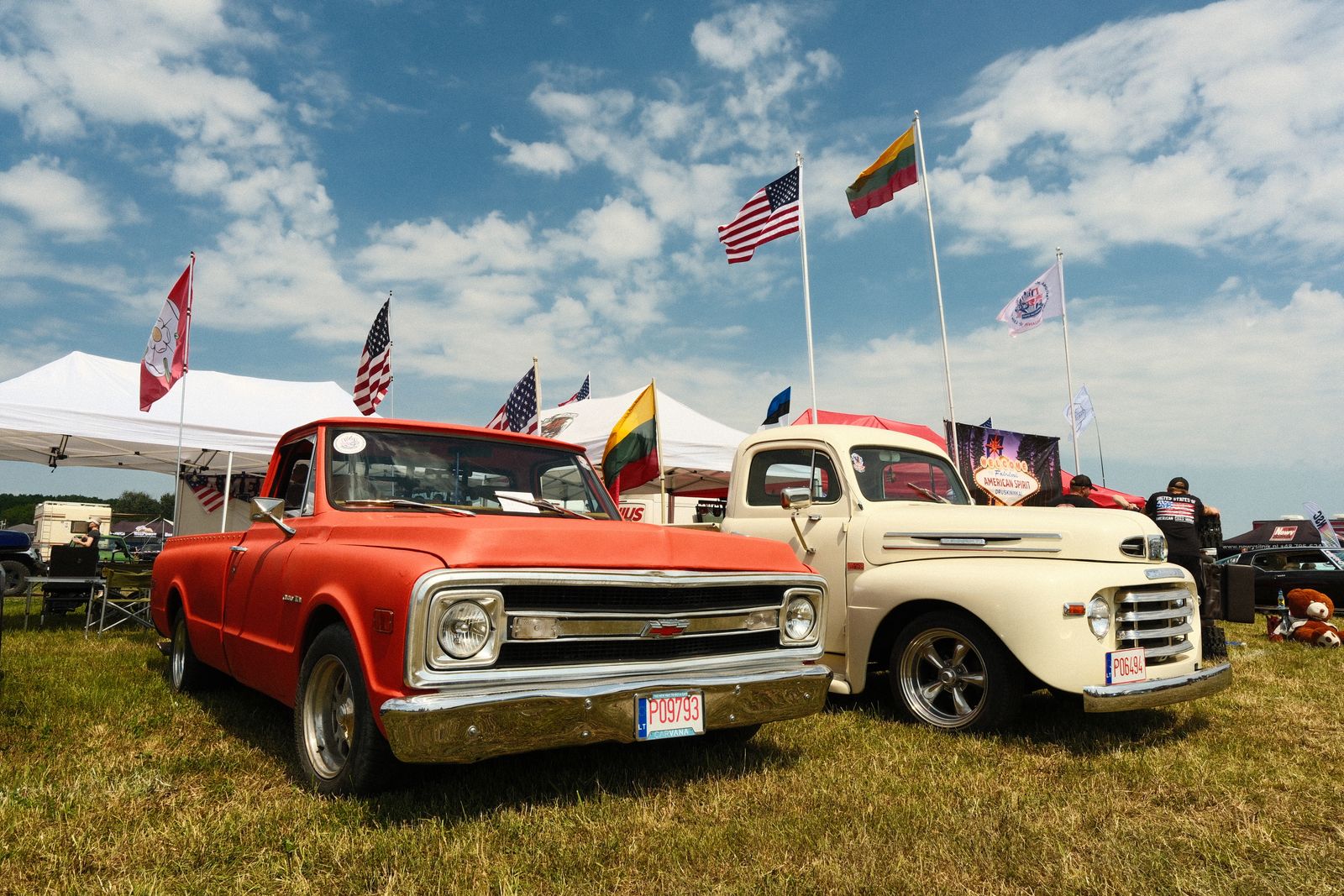 Classic trucks and flags at a community car show