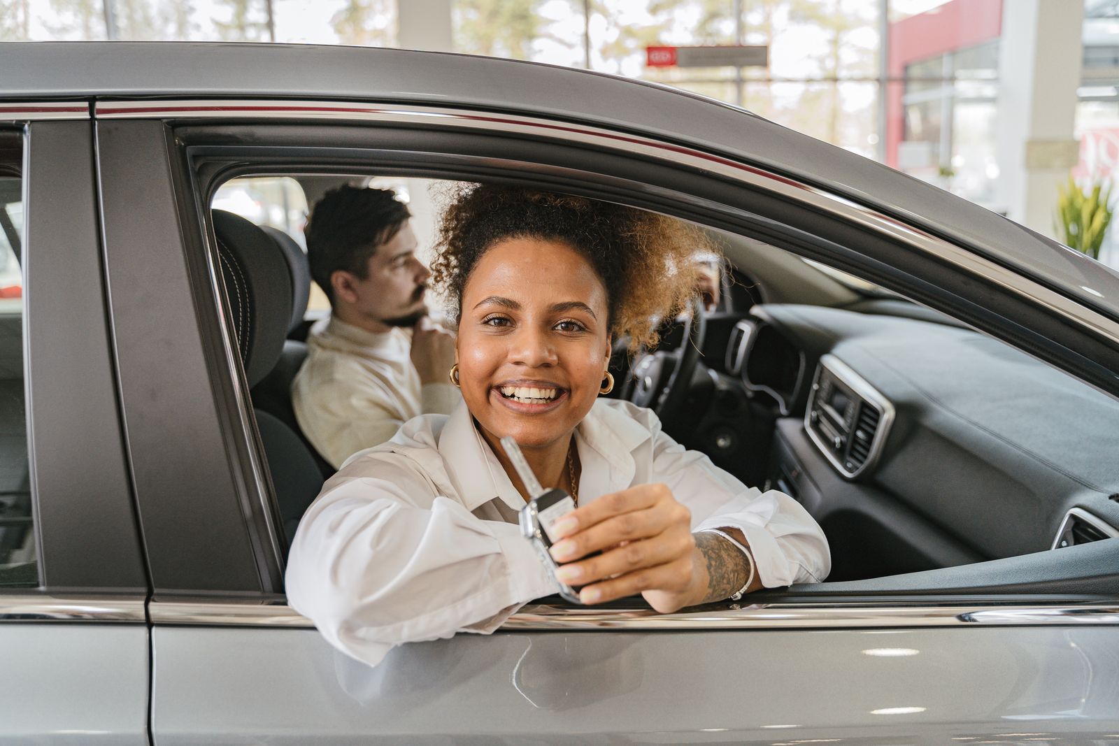 Couple smiling in their newly cleaned car
